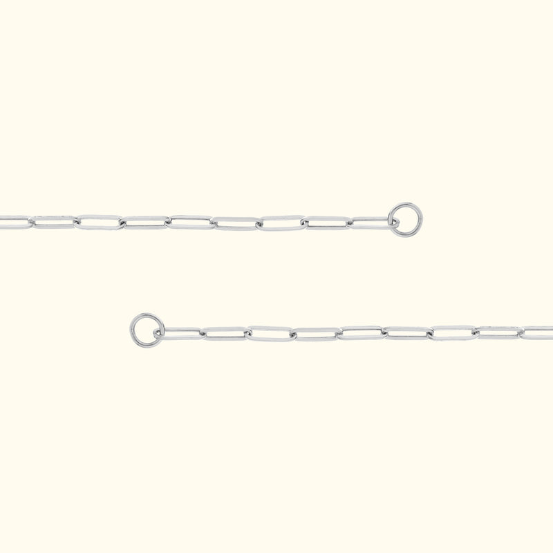 Delicate silver link chain with connection rings on either end, set against a light background.