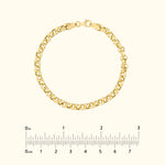 Gold chain bracelet on a light background, with a measurement scale below.