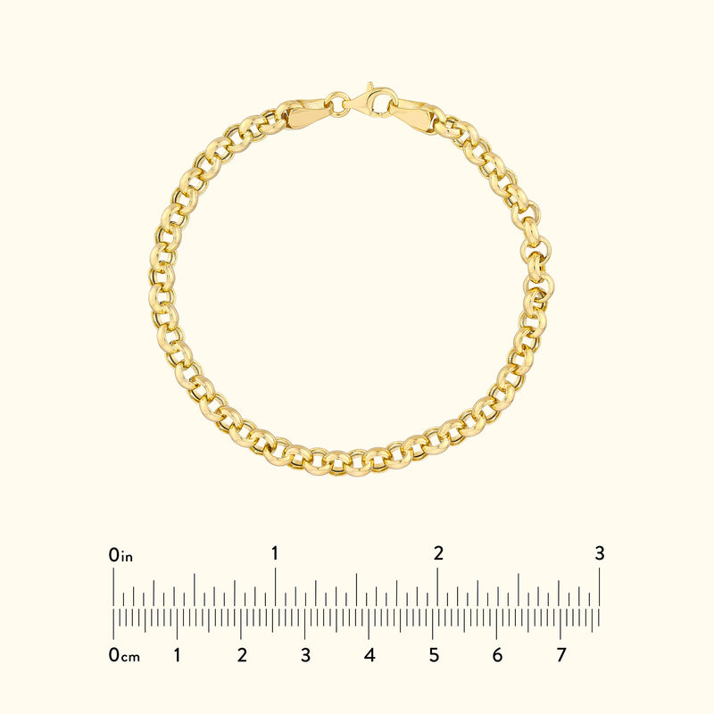 Gold chain bracelet on a light background, with a measurement scale below.