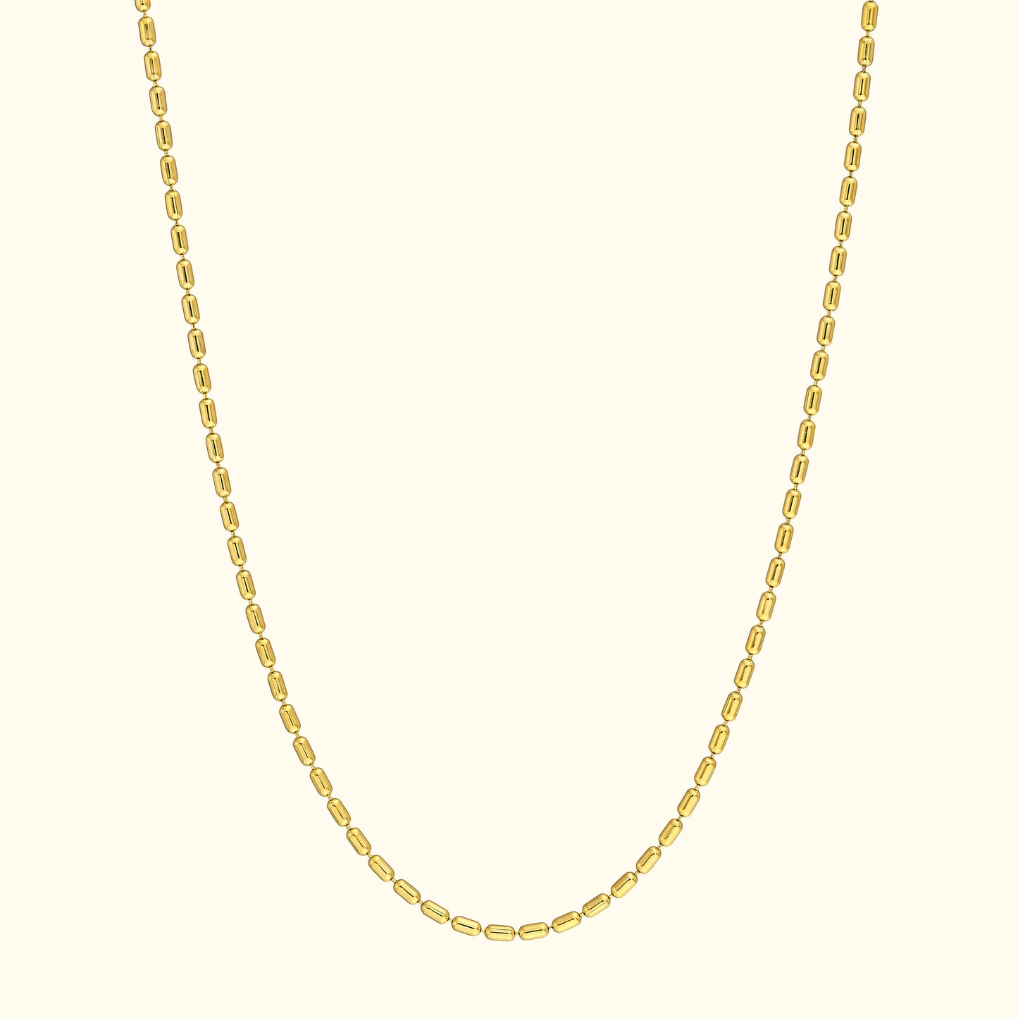 Simple gold chain necklace with oval links against a light background.