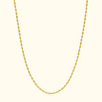 Simple gold chain necklace with oval links against a light background.