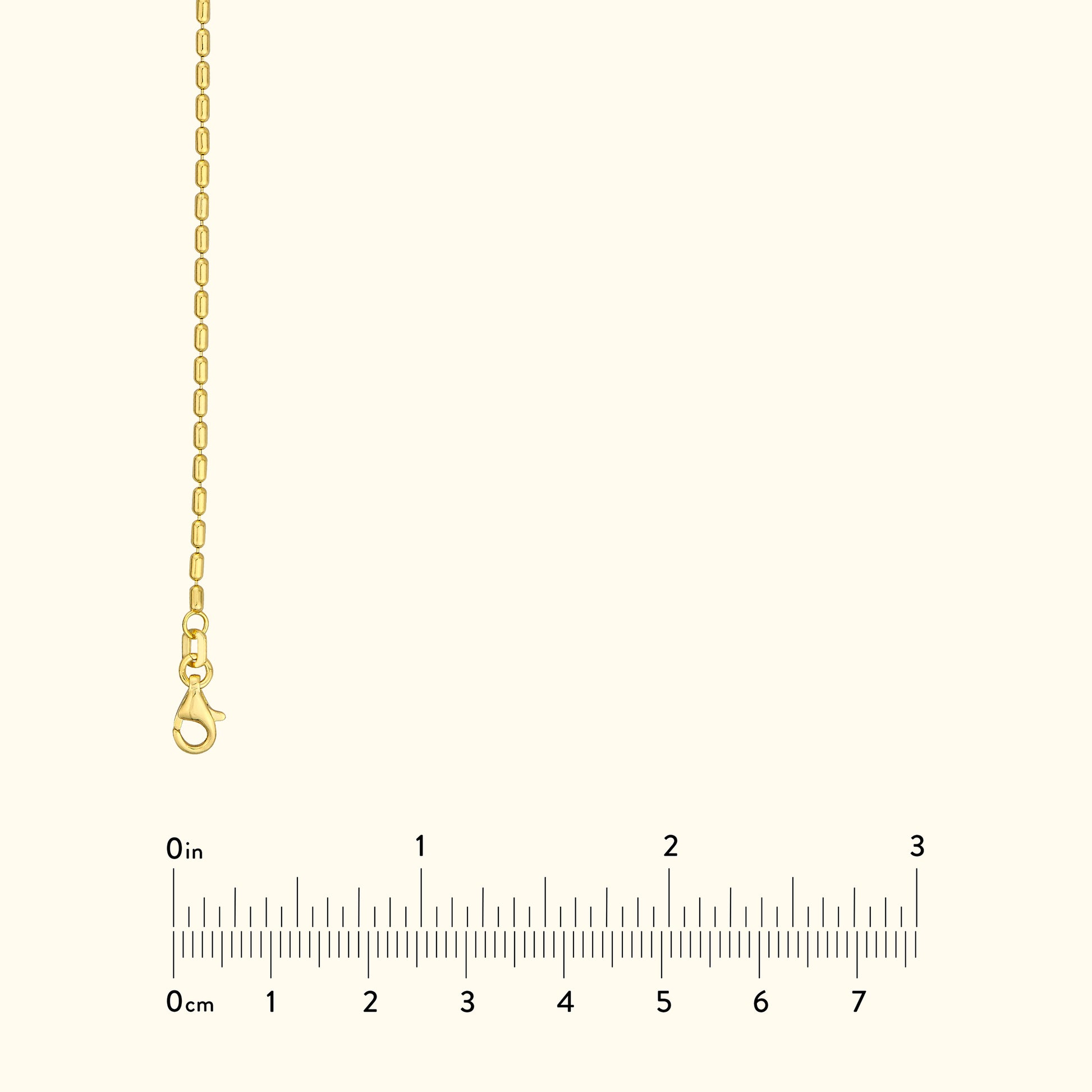 Thin gold chain necklace with a lobster clasp against a light background.