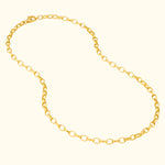 Gold chain necklace with linked oval shapes, on a light background.