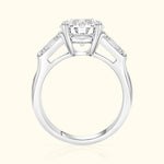 Elegant silver engagement ring featuring a central diamond and two side stones.