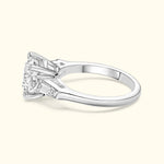 Elegant silver engagement ring featuring a large center diamond and side step-cut diamonds.