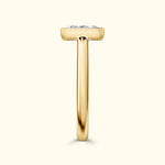 Elegant gold ring showcasing a large diamond on a slender band.