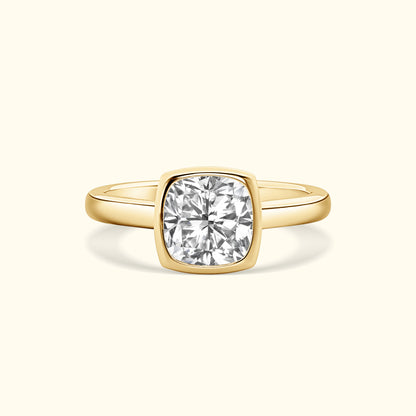 Gold ring with a large, round, sparkling diamond in a cushion setting.