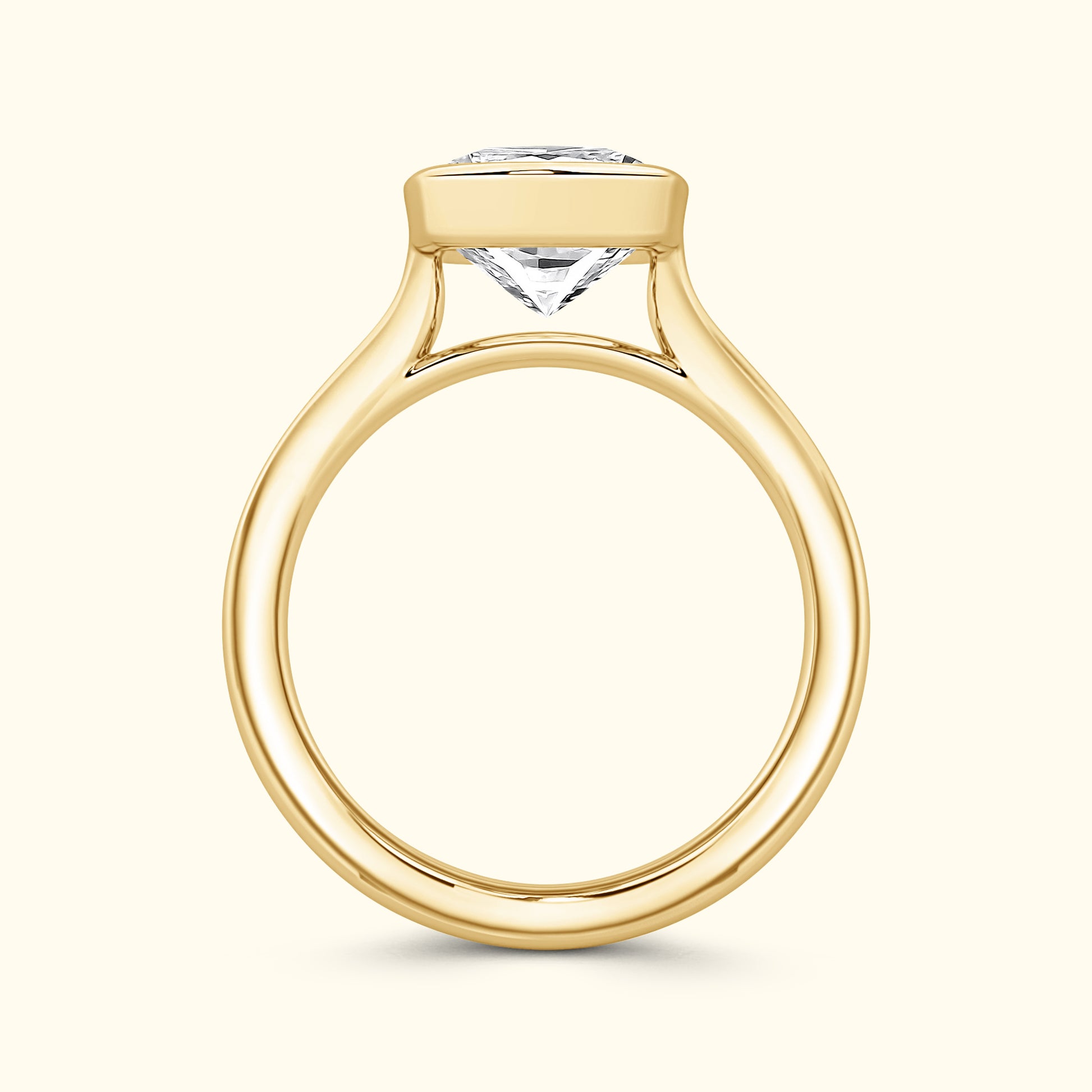 Elegant yellow gold engagement ring featuring a prominent diamond set in a minimalist design.