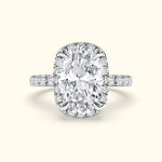 Sparkling oval diamond ring with a halo setting and delicate band.