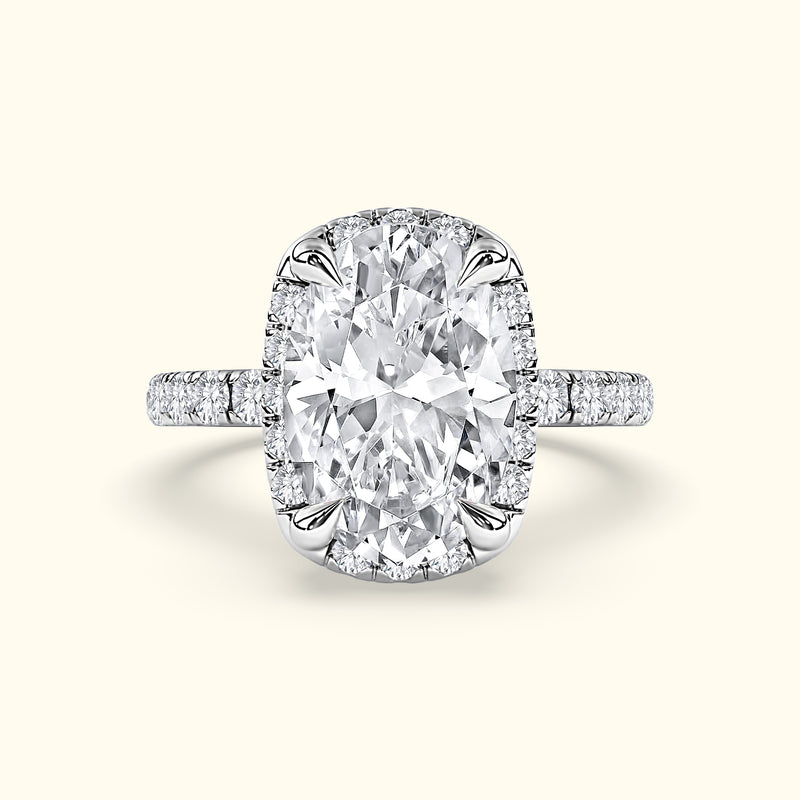 Sparkling oval diamond ring with a halo setting and delicate band.