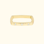 Gold rectangular ring featuring three small, sparkling diamonds.