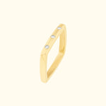 Yellow gold ring with three small diamonds set in a modern, angular design.