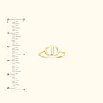 Simple gold ring with an oval design, placed against a light background with a ruler.