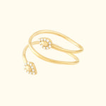 Two intertwining gold rings with teardrop-shaped ends adorned with small diamonds.
