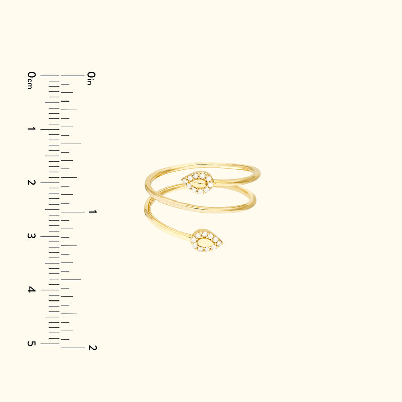 Gold double band ring featuring two teardrop designs, each adorned with small stones.