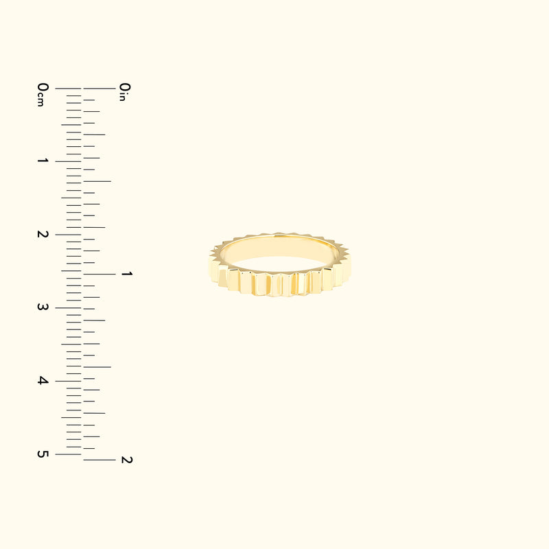 Gold band ring with a textured, ridged design displayed against a light background.