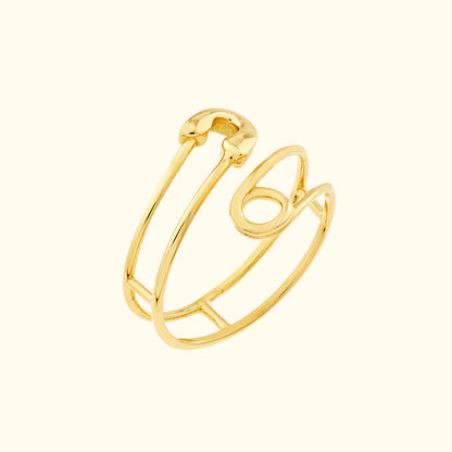 Gold wire ring with an open design featuring curved and angular shapes.