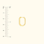 Gold oval-shaped jewelry connector with a textured edge on a light background.
