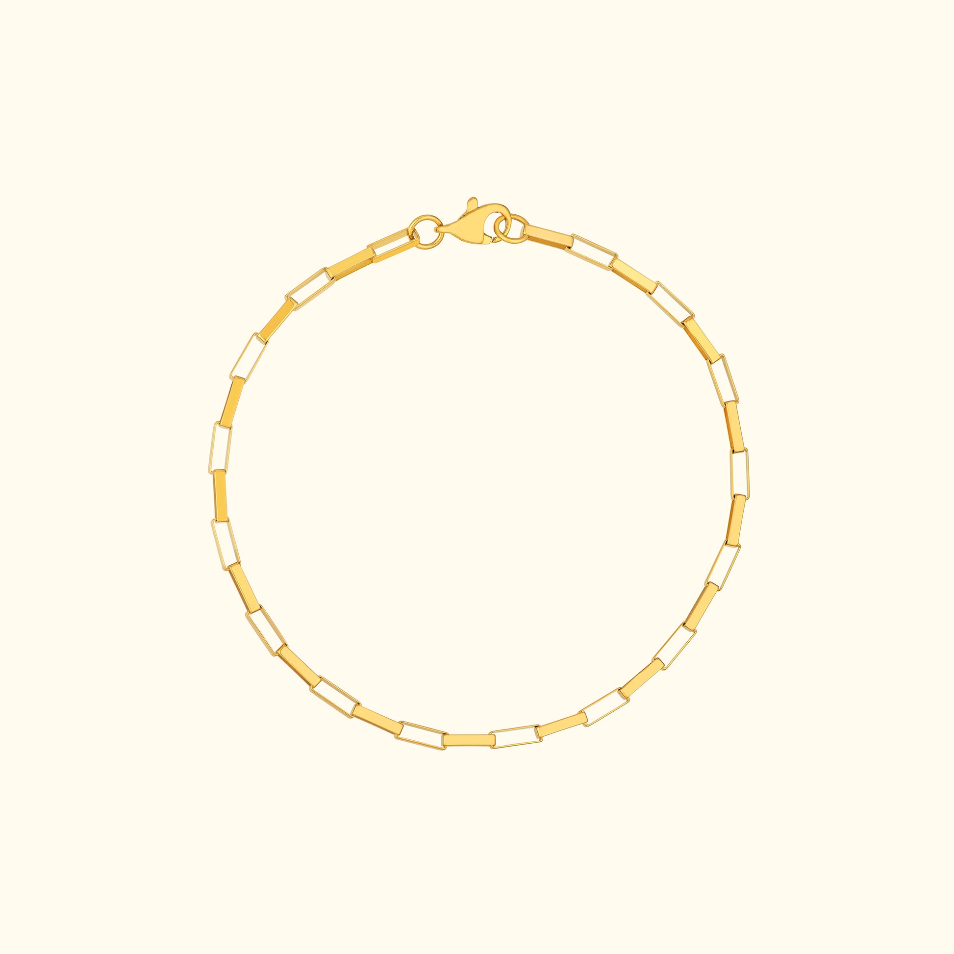 Gold chain bracelet with alternating rectangular links and a lobster clasp.