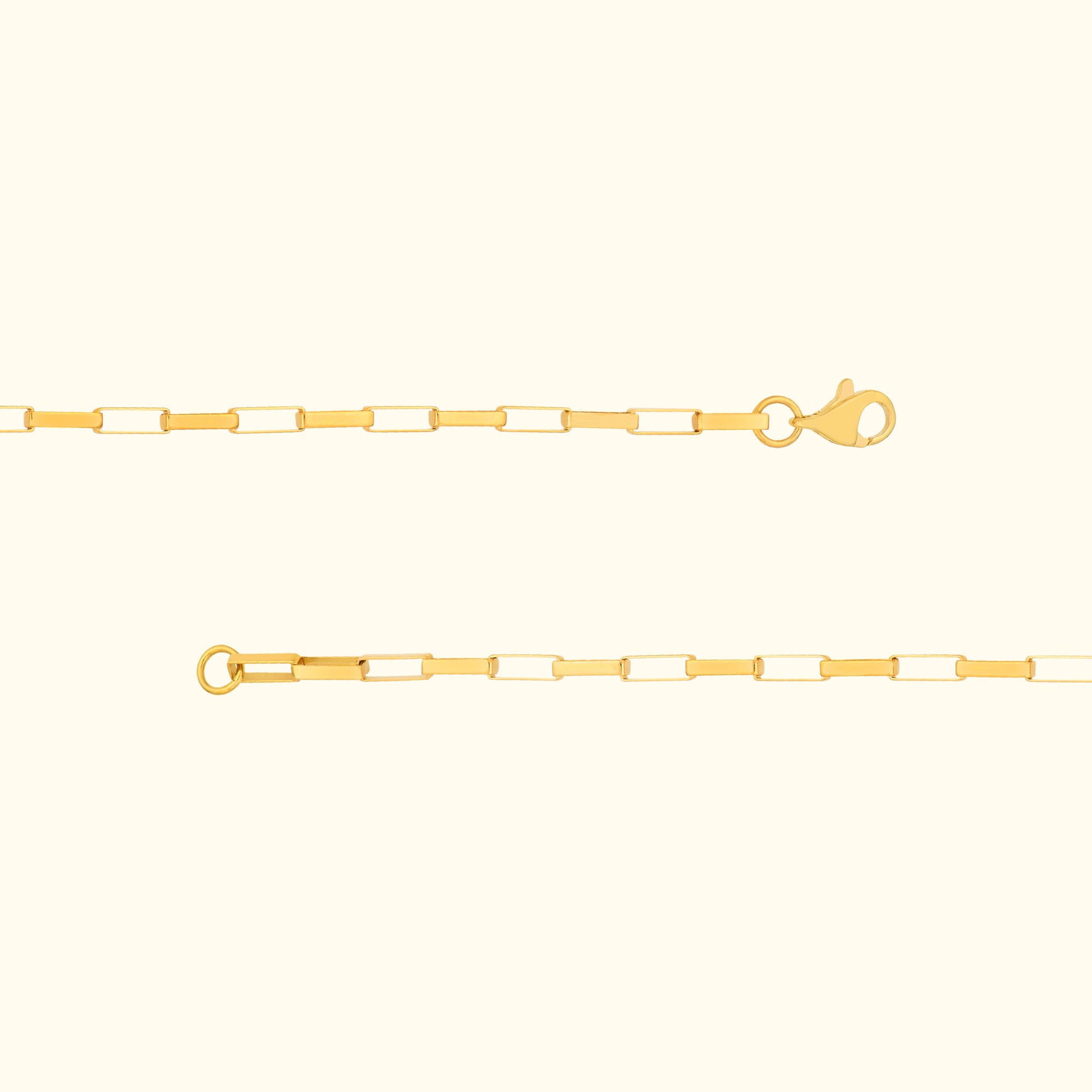 Thin golden chain with a lobster clasp and circular loop, designed for necklaces or bracelets.