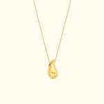 Gold pendant necklace with a teardrop-shaped charm on a delicate chain.