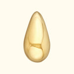 Polished gold teardrop pendant on a light background.