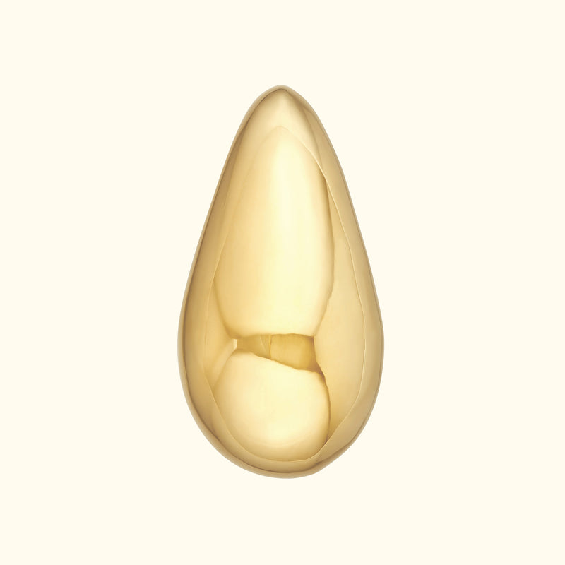Polished gold teardrop pendant on a light background.