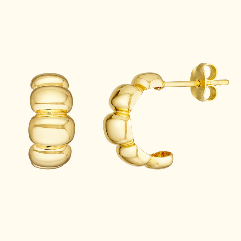 Gold hoop earrings with a smooth, rounded design, showcasing a modern, polished finish.
