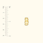 Gold ring with three rounded elements, displayed against a light background.