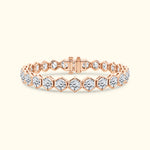 Rose gold bracelet with hexagonal links and clear gemstones.