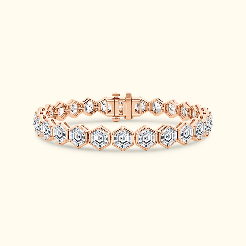 Rose gold bracelet with hexagonal links and clear gemstones.