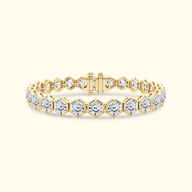 Gold and diamond bracelet featuring a hexagonal design on a soft beige background.