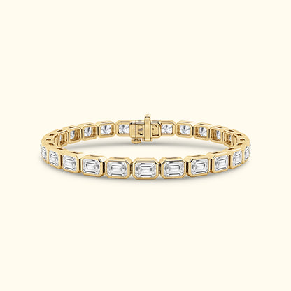 Gold and diamond bracelet with rectangular stones, featuring an elegant clasp.