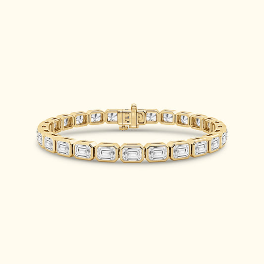 Gold and diamond bracelet with rectangular stones, featuring an elegant clasp.