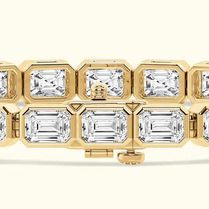 Gold bracelet with rectangular diamonds, featuring an elegant clasp design.