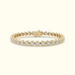 Gold tennis bracelet featuring round diamonds set in a sleek prong setting.