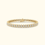 Elegant gold bracelet with round diamonds set in a delicate line pattern.