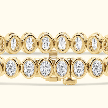 Gold bracelet with alternating oval and round diamonds, showcasing a sparkling design.