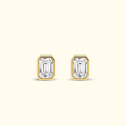 Emerald-cut diamond stud earrings set in gold.