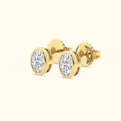 Gold stud earrings with round, sparkling diamonds.