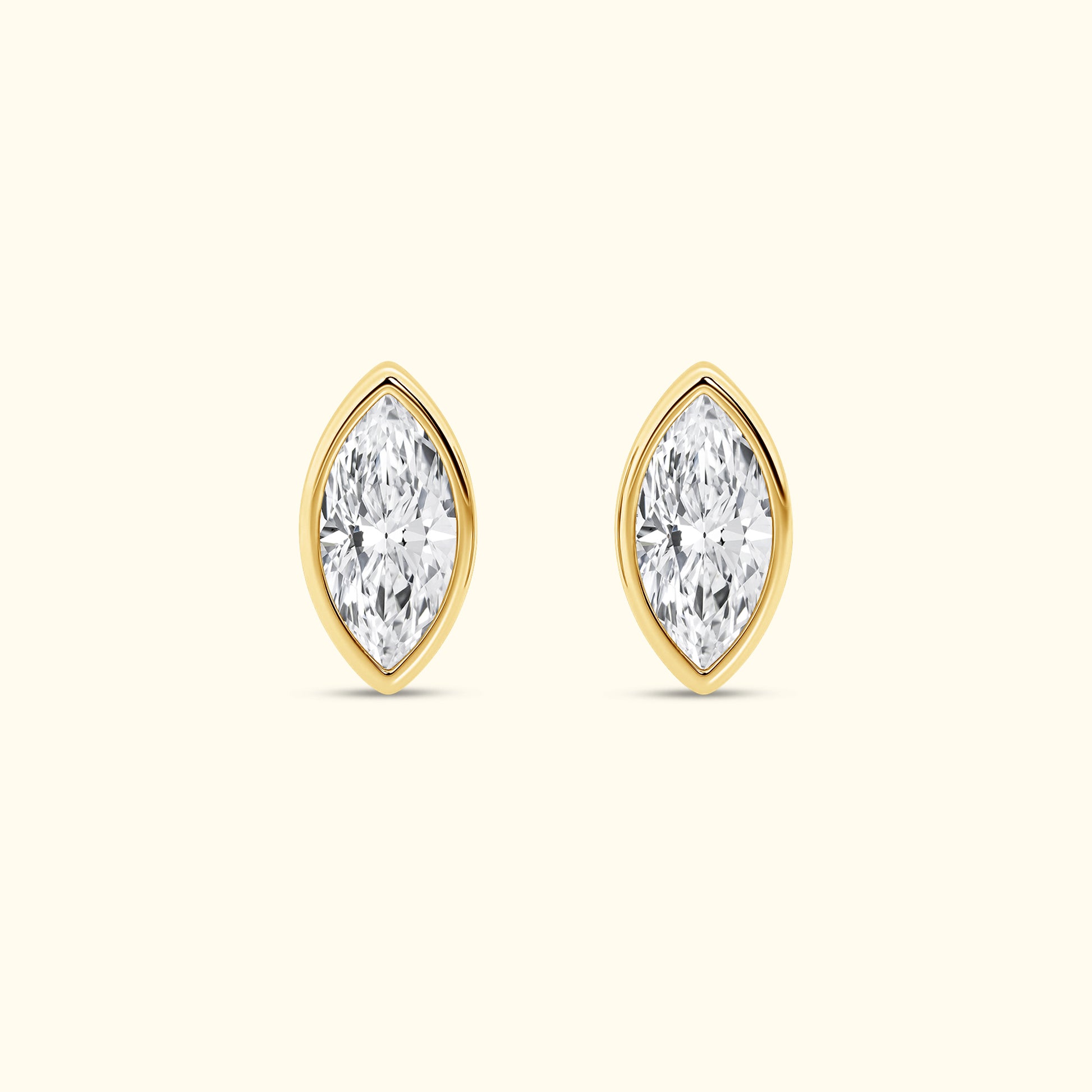 Marquise-cut diamond stud earrings set in yellow gold.