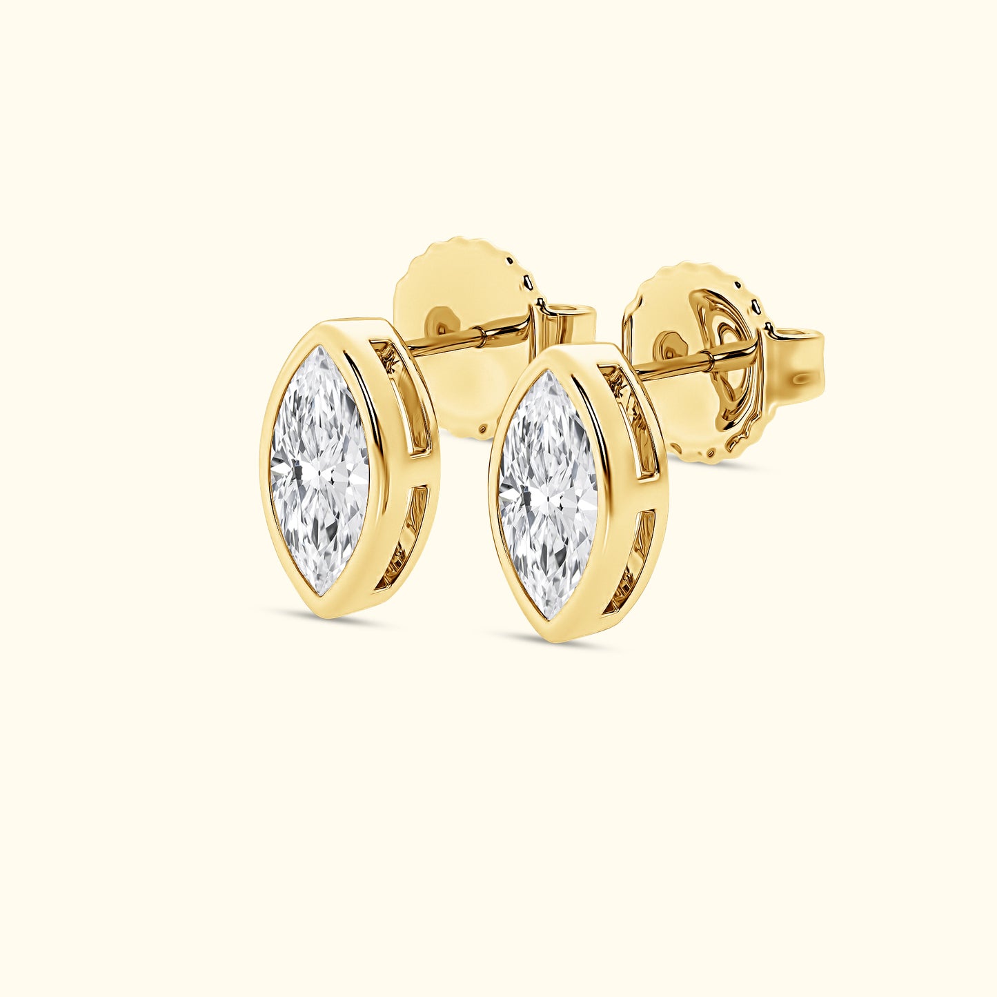 Gold marquise diamond stud earrings with a polished finish.