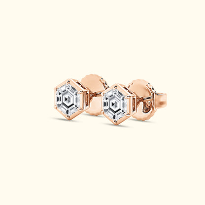 Rose gold hexagonal stud earrings featuring clear, sparkling gemstones.