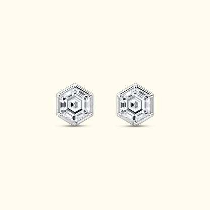 Hexagonal crystal earrings with a clear, geometric design on a light background.