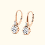 Rose gold hexagonal earrings with clear gemstones.