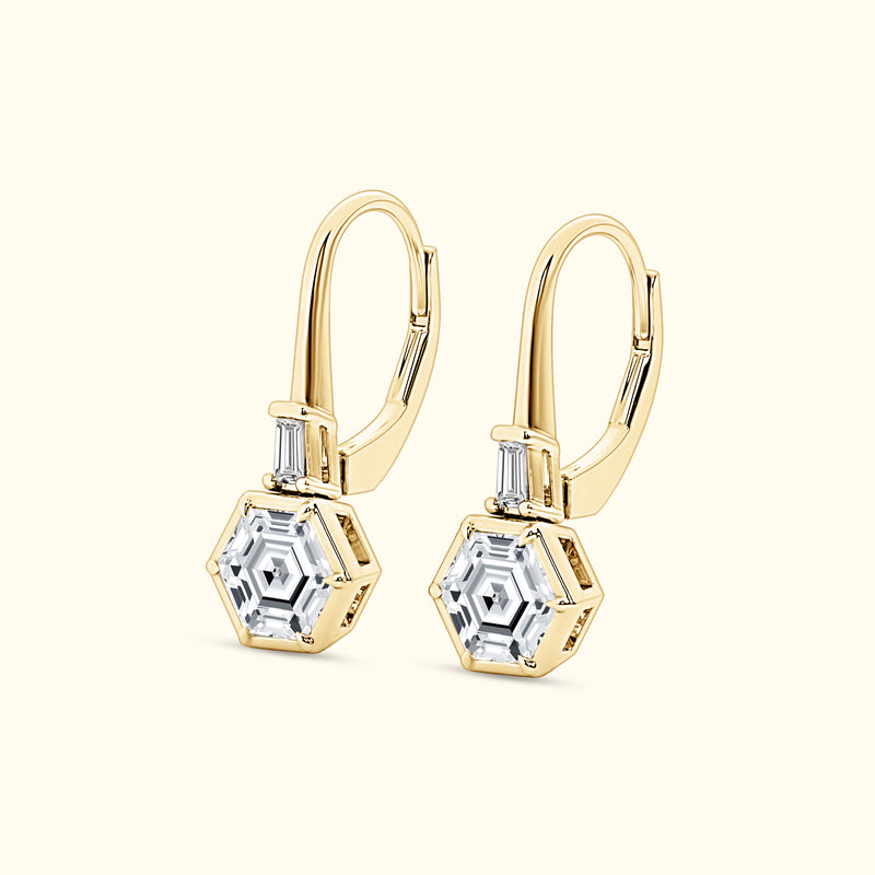 Gold hexagonal earrings with clear stones and a sleek design.