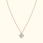 Rose gold necklace featuring a hexagonal pendant with a central diamond.