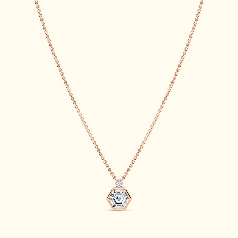 Rose gold necklace featuring a hexagonal pendant with a central diamond.