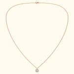 Delicate rose gold necklace featuring a hexagon pendant with a central gemstone.