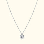 Silver hexagonal pendant on a delicate chain against a light background.